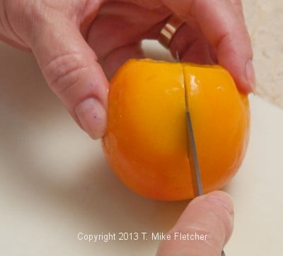 Cutting a peach in half
