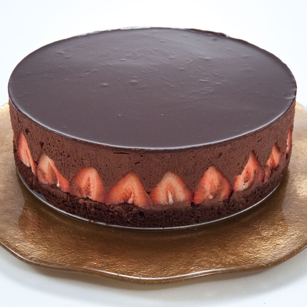 Chocolate Strawberry Mousse Torte on a golden plate.