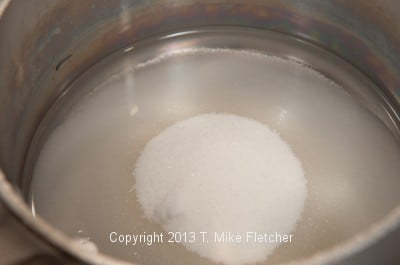 Sugar and water in pan