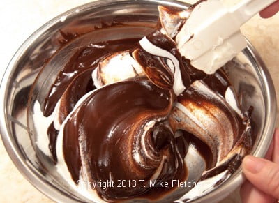Folding cream into dark chocolate