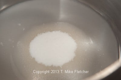 Water,sugar and corn syrup in pan