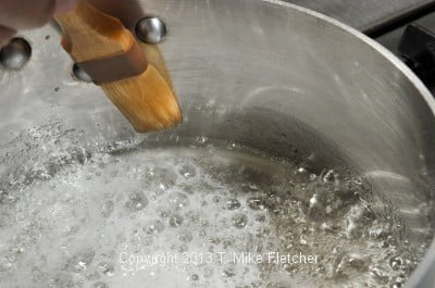 Washing down sides of pan
