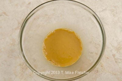 egg yolks in bowl with coffee mixed