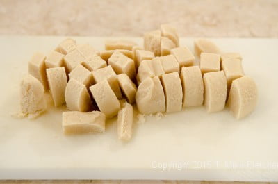 Almond paste cut up to be processed