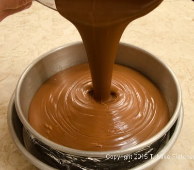 Pouring Triple Chocolate Cheesecake into pan