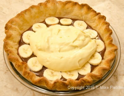 Half the pastry cream over bananas for the Double Banana Caramel Cream Pie