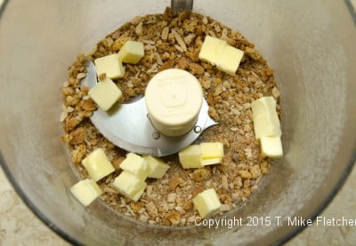 Butter in processor with amaretti crumbs to be processed for Baked Pluots with Amaretti Crumble