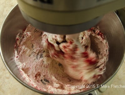 Beating raspberries into buttercream