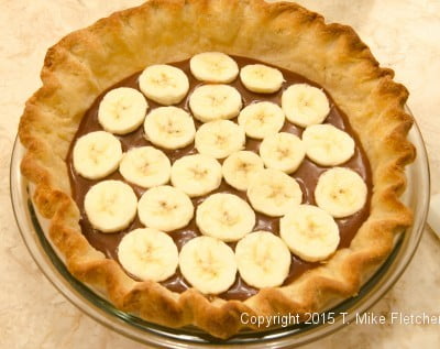 Bananas covering caramel for the Double Banana Caramel Cream Pie