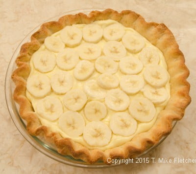 Bananas over the pastry cream for theDouble Banana Caramel Cream Pie