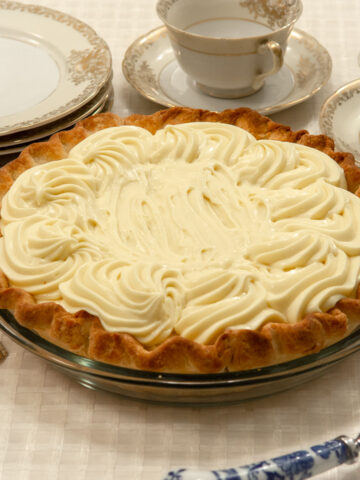 Double Banana Cream Pie with plates and cups and saucers.