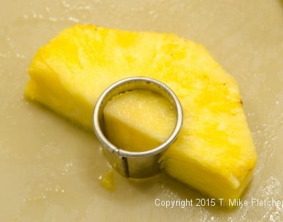 Cutting core out of pineapple for the Pina Colada Cake