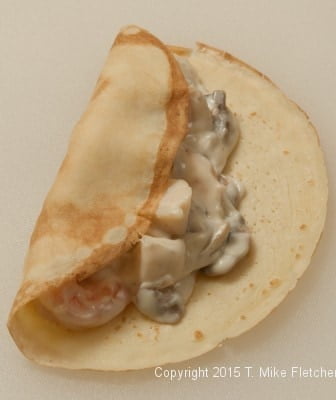 Left side of crepes folded over for Seafood Crepes
