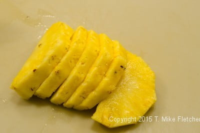 The pineapple sliced in half for The Pina Colada Cake