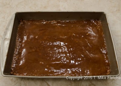 Caramel over the base of the Hazelnut Crunch Bars