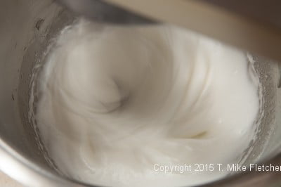 Egg whites beaten to soft peaks before the sugar syrup is added for Hazelnut Crunch Bars