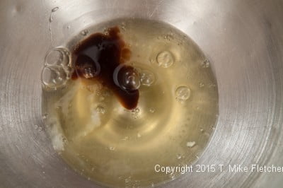 Eggs whites and vanilla in mixing bowl for Hazelnut Crunch Bars