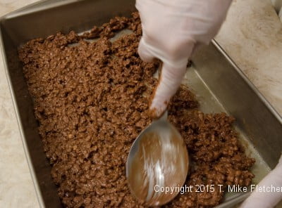 Spreading base in the bottom of the pan for Hazelnut Crunch Bars