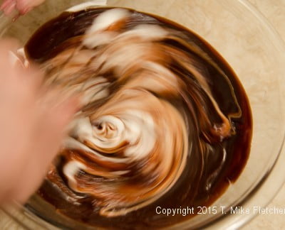 Stirring whites into chocolate mousse for the Double Chocolate Mousse Cake