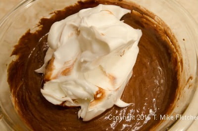 Cream and whites on top of chocolate mixture for the Double Chocolate Mousse Cake