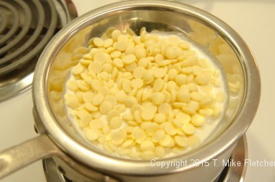 White Chocolate Mousse ingredients over a double boiler for the Double Chocolate Mousse Cake