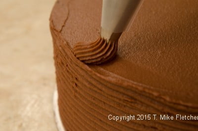 Piping the top of the cake for the Double Chocolate Cake