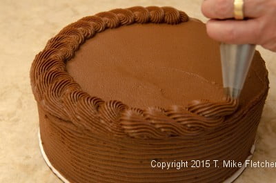 Piping the top of the cake for the Double Chocolate Mousse cake