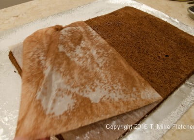 Removing the parchment from the bottom of the spongecake for the Buche de Noel