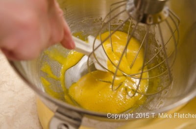 Scraping the bottom of the bowl with the egg yolks for the Buche de Noel