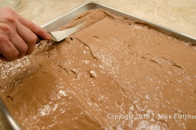 Spreading chocolate spongecake for the Buche de Noel