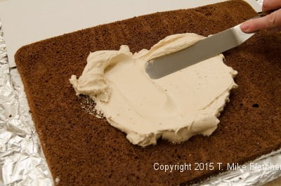 Spreading buttercream on spongecake for Buche de Noel