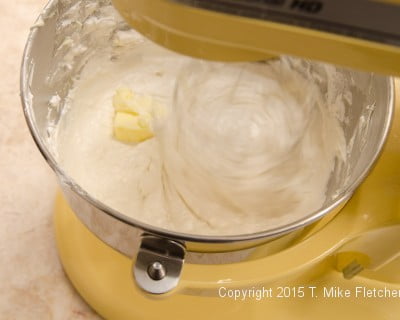 Adding butter to the buttercream for the Buche de Noel