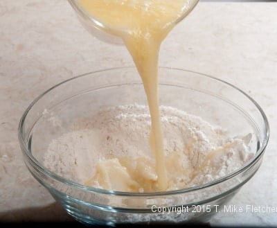 Liquid ingredients being poured into dry ingredients