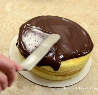Glaze on top of the cake for the Boston Cream Pie