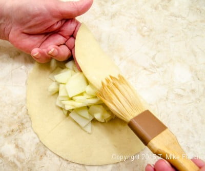Brushing with water for Apple Crostatas with Pastry Cream