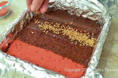 Toffee being sprinkled on for the Two Ingredient Fudge Hearts