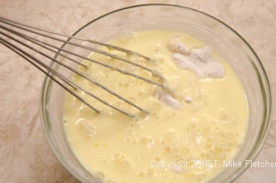 Whisking liquid ingredients into flour for The Lemon Raspberry Pudding Cake