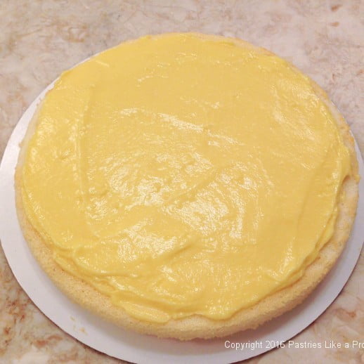 bottom-layer-of-cake-with-lemon-curd--for-lemon-blueberry-cake.jpeg