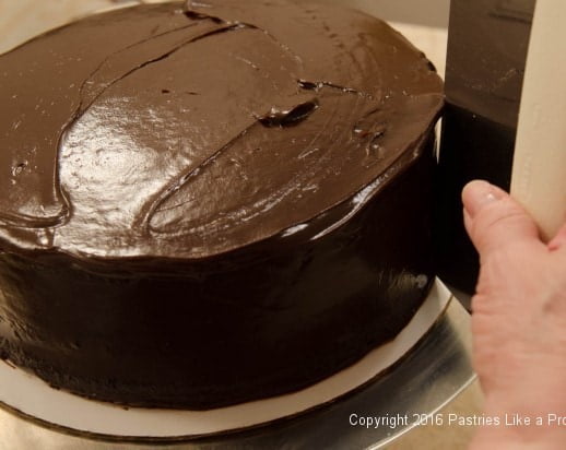 Smoothing sides of cake for Why, When and How to Undercoat a Cake