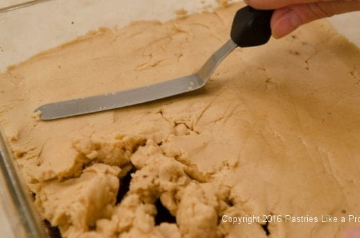 Spreading filling over the crust for the No Bake Peanut Butter Bars