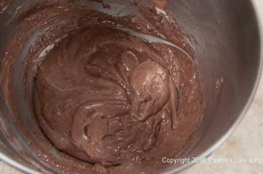 Cocoa mixed into cake for the Chocolate raspberry Gateau