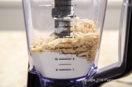 Nuts and powdered sugar in blender for How to Make Almond Paste