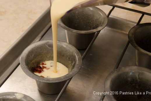 Pouring batter into cups for the Bacon and Cheddar Cheese Popovers