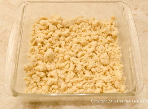 Crumbs spread evenly in the bottom of the pan for the Deep Butter Cake