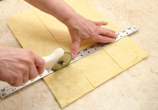 Cutting dough into squares for Kouign Amann