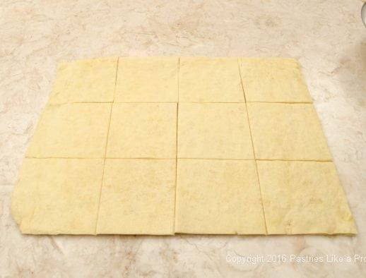 Twelve dough squares cut for Kouign Amann