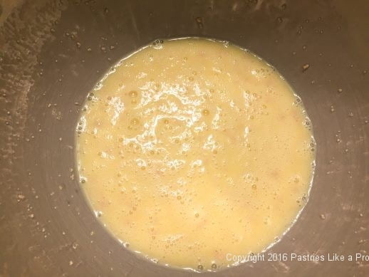Butter and milk in a mixing bowl for Brandied Chocolate Cherry Almond Garmisch