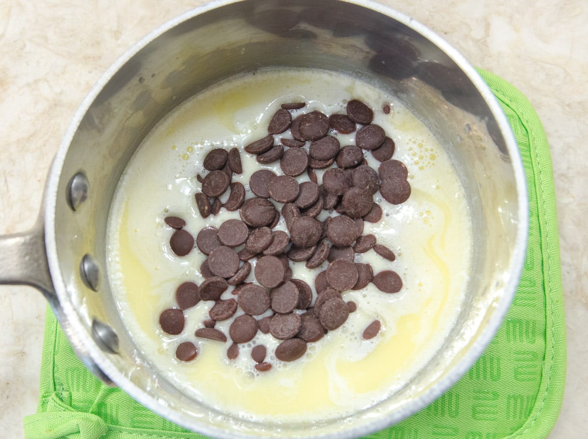 The chocolate is poured into the hot cream mixture to melt.