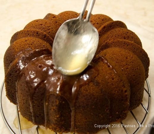 Spooning syrup over cake for the Lemon Rum Bundt Cake