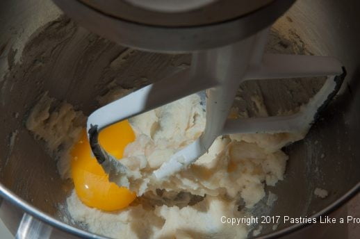 Egg yolk and vanilla added to crumb mixture for Easily Made Raspberry Ripple Coffeecake